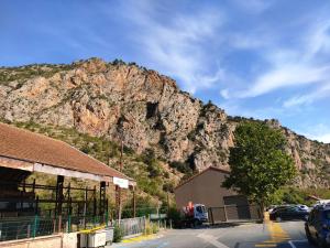 a mountain in front of a building with a parking lot at saint cyprien plage in Saint-Cyprien