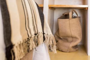 a group of bags are hanging on a shelf at Sea'Ya Thoughtful Stays - Villas in Cascais