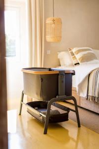 a bedroom with a bed with a table next to it at Sea'Ya Thoughtful Stays - Villas in Cascais