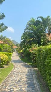 a cobblestone road in a garden with palm trees at Hua Hin in Hua Hin