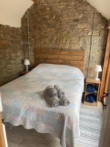 a bedroom with a bed with towels on it at Beautiful countryside Byre conversion in Shrewsbury