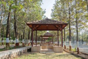 a pavilion in the middle of a park with trees at GP Hotels and Resorts in Nashik