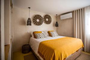 a bedroom with a bed and two mirrors on the wall at Sea'Ya Thoughtful Stays - Villas in Cascais
