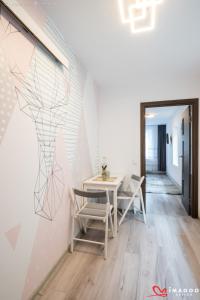a dining room with a table and chairs at Long street suites in Braşov