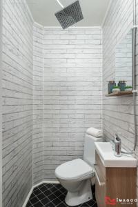 a white bathroom with a toilet and a sink at Long street suites in Braşov +17 photos