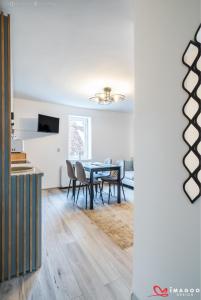 a dining room with a table and chairs at Long street suites in Braşov