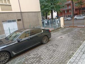 a car parked in a parking lot next to a fence at Casa Gramsci in Modena