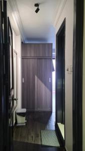 a hallway with a wooden cabinet and a door at Hanoi Lucky Hostel in Hanoi