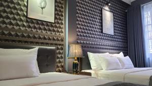 a hotel room with two beds and a lamp at Hanoi Lucky Hostel in Hanoi