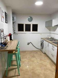 cocina con mesa y lavadora en Precioso apartamento en zona de playa, en Almería