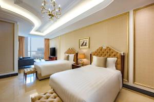 Dusit Hotel & Suites - Doha房間的床