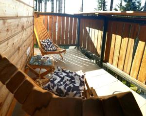 a porch with a hammock and a chair at Golte SkiCenter Apartment in Mozirje