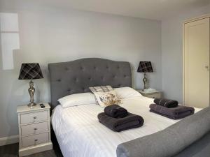 a bedroom with a bed with two towels on it at The Finch Hatton Arms in Sleaford