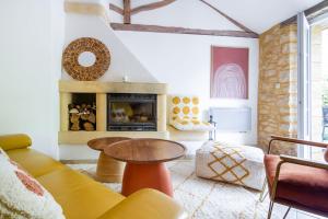 a living room with a couch and a table at Le Clos Vallis in Sarlat-la-Canéda