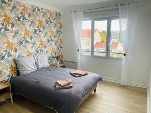 a bedroom with a bed with two towels on it at Spacieux T2 à 15mn de Paris et 30mn de Disney en voiture ! in Champigny-sur-Marne