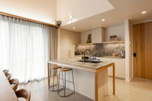 a kitchen with a sink and a counter with stools at John and Jane's Beechworth in Beechworth