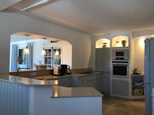 a kitchen with white cabinets and a counter top at Villa "La vie est belle...!" in Cavalaire-sur-Mer