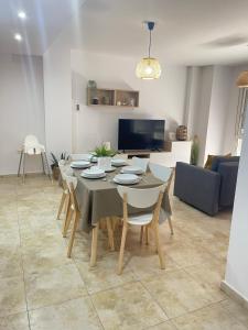 a dining room with a table and chairs in a living room at UIM Mediterraneo FELIPE 8 WIFI in Puerto de Sagunto