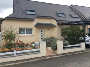 a house with a white fence in front of it at A l'Orée de Bruz in Pont-Péan