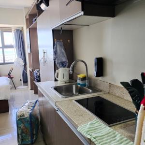 a kitchen with a sink and a counter top at eutz condominium daily rental in Cebu City