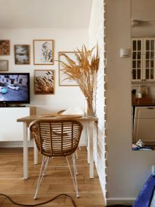 a dining room with a table and a chair at Boho apartament - studio in Kołobrzeg