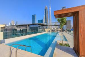 a swimming pool on the roof of a building at Largest 2BR Family Suite w Maid's Room, City Walk in Dubai