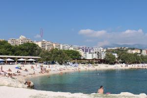 a beach with a bunch of people in the water at Beachside Apartments Znjan in Split
