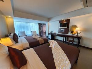 Postel nebo postele na pokoji v ubytování Goldenbell Hotel Chiangmai
