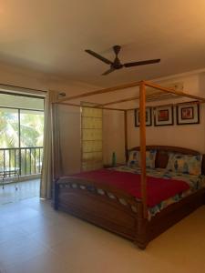 a bedroom with a bed with a ceiling fan at Riviera Hermitage in Anjuna +146 photos