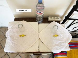 a table with two towels and a bottle of water at Nice Center Room in Nice