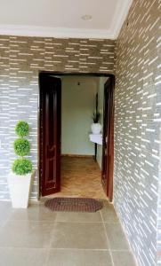 a hallway of a house with a brick wall at 3 Bedrooms house for Short let Holiday Apartments in Ibadan