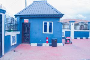 a blue building with a black roof at 3 Bedrooms house for Short let Holiday Apartments in Ibadan