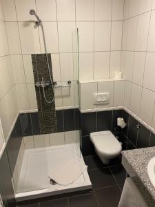 a small bathroom with a shower and a toilet at Villa Natura in Dolsk