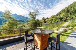 a table and chairs on a balcony with a view at Pension Sonnegg in Saltusio