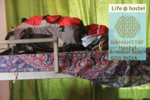 a pile of luggage sitting on top of a bunk bed at NamahStay Hostel, Cowork & Artist residency Arambol in Arambol