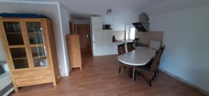 a room with a table and chairs and a kitchen at Am Habichtsweg 2te. in Lengerich