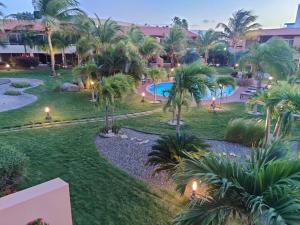 an aerial view of a resort with a pool and palm trees at Luxury two-bedroom townhome in few steps from Eagle Beach in Palm-Eagle Beach