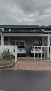 a car parked in front of a house with a garage at Muji Homestay Ria Heights Tawau in Tawau