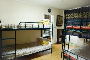 a room with three bunk beds and a room with at UB Guesthouse & Tours in Ulaanbaatar
