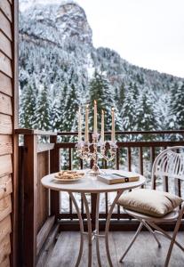 einen Tisch und zwei Stühle auf einem Balkon mit Aussicht in der Unterkunft Bad Ratzes in Seis am Schlern