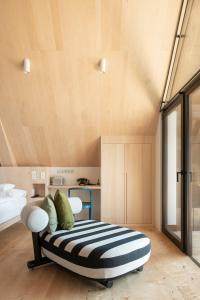 a bed sitting on top of a wooden floor in a room at Miramonti Boutique Hotel in Avelengo