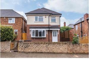 a brick house with a brick retaining wall at Carrington 3 Bedroom Home, FREE PARKING and Close to the City Centre in Nottingham