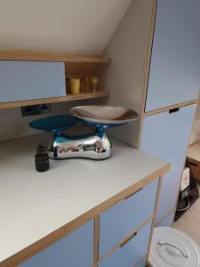 a room with a table and a stool on a counter at London Sky Home - stunning 3 bed apt in the Sky in London