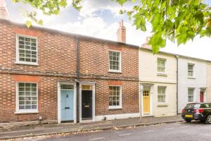 a brick building with a blue door on a street at The Victorian House - Enticing 3BDR House with Garden in Oxford