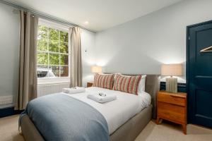a bedroom with a large bed and a window at The Victorian House - Enticing 3BDR House with Garden in Oxford