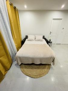 um quarto com uma cama num quarto com amarelo e branco em Paname ou Rouen ? em Freneuse
