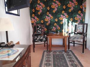 a living room with two chairs and a table at Camino Art House in Vega de San Mateo