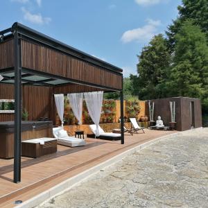 a pavilion with white chairs on a wooden deck at Quinta do Guerra in Boldrarias