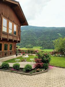 Casa con patio y jardín con flores en Gästehaus Moser, en Ranten