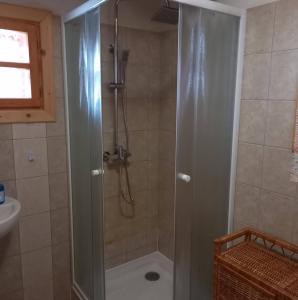a shower with a glass door in a bathroom at Chata U Juraja in Hruštín